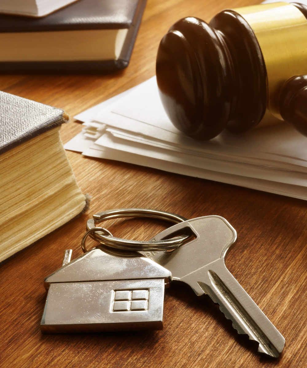 Property law concept. Key from real estate and gavel.